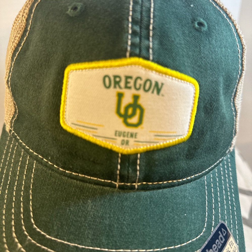 Oregon University Green and White snap back cap.